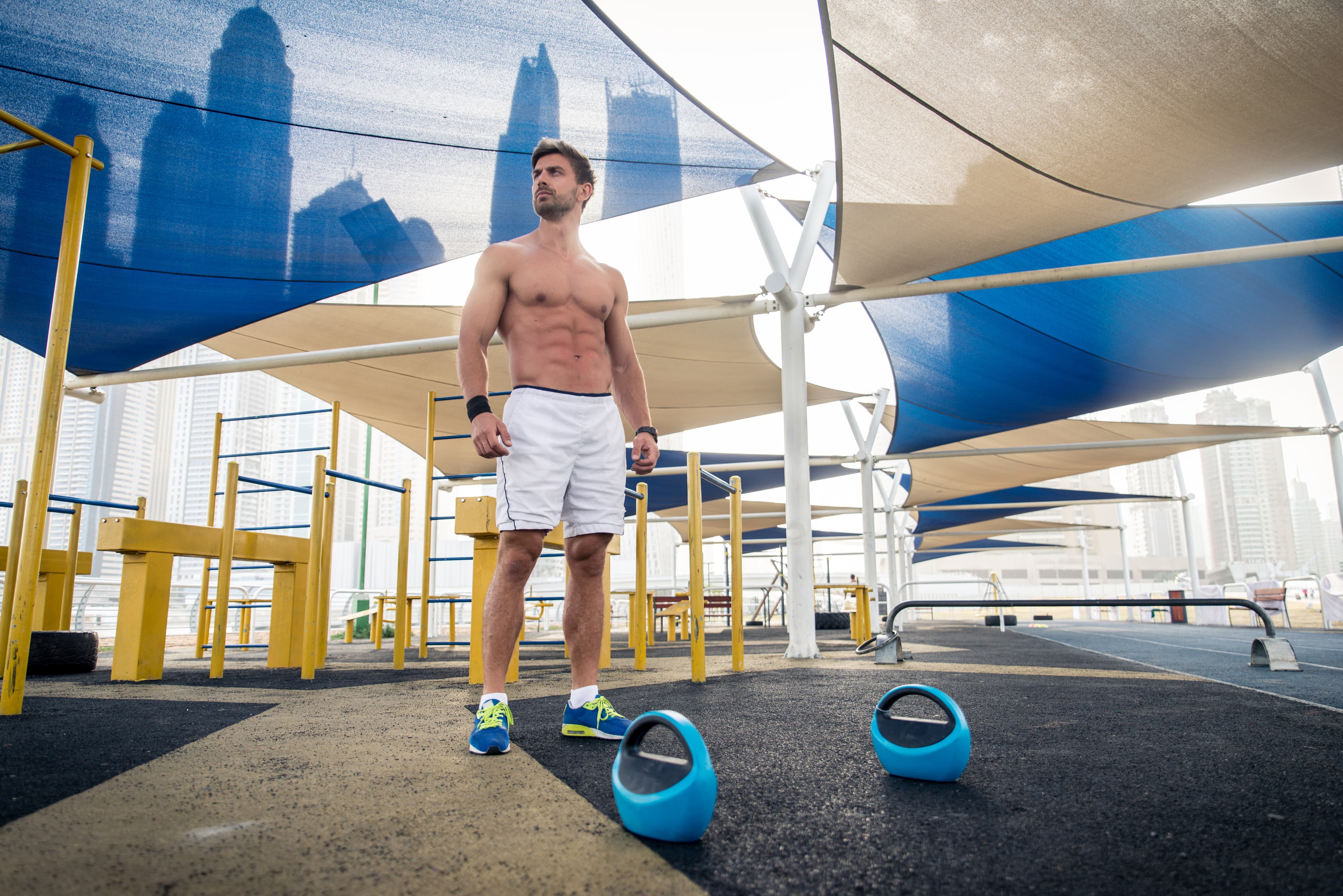 Athletic man working out at an outdoor gym